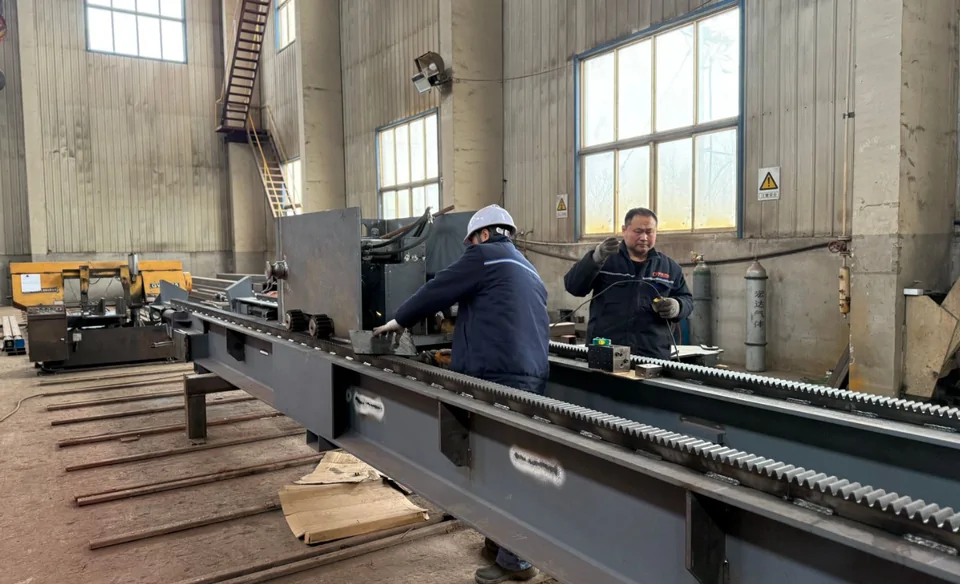 Qingwei technicians assembling the rack system along a tube bundle extractor chassis